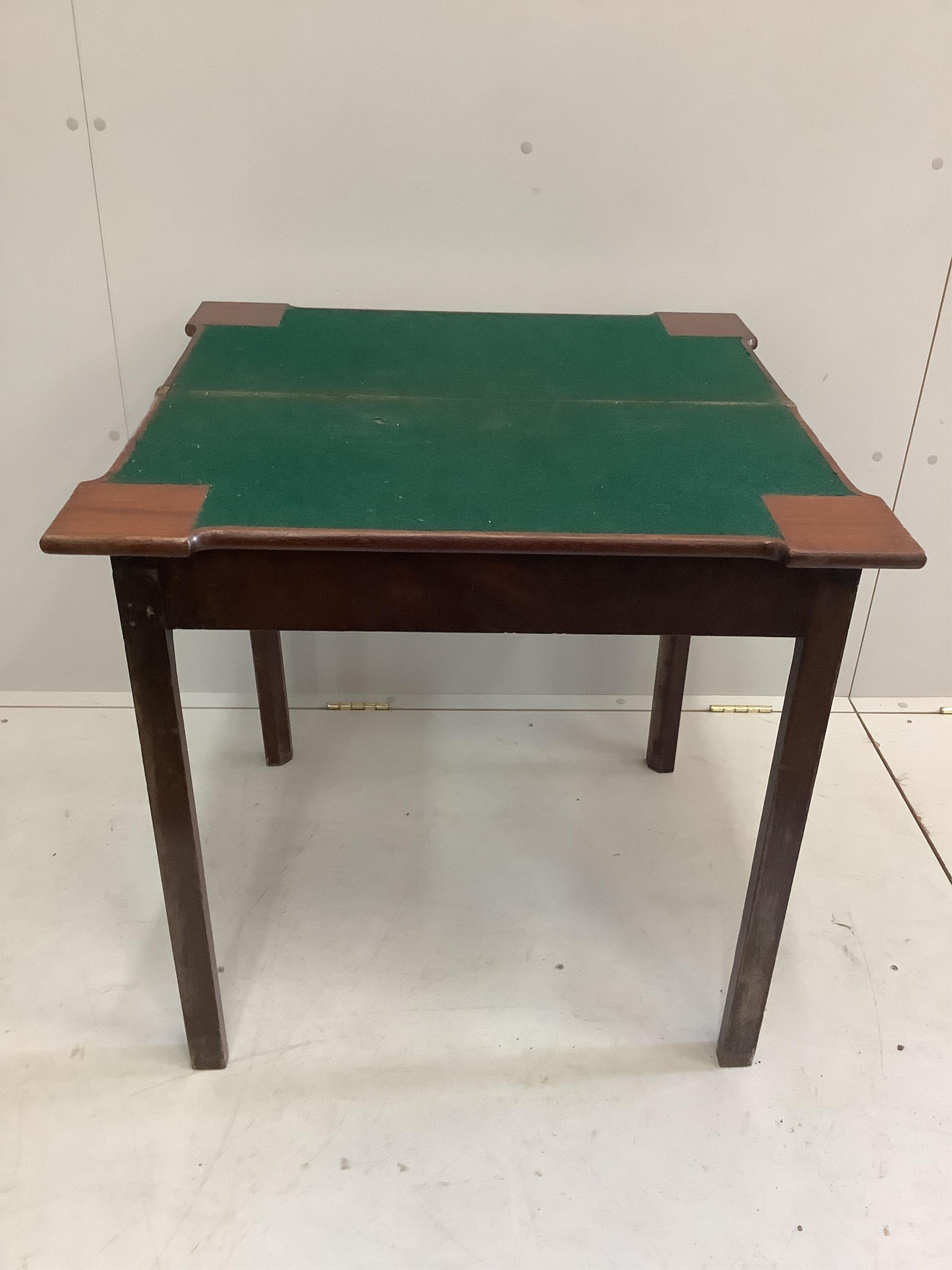 A George III mahogany folding card table, width 74cm, depth 37cm, height 73cm. Condition - fair